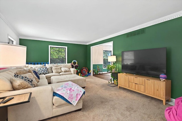 carpeted living room featuring ornamental molding