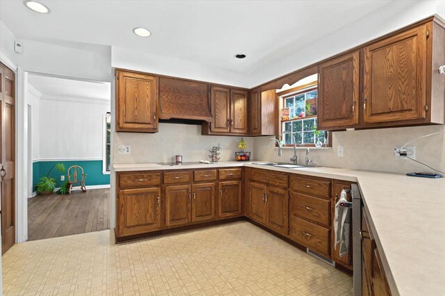 kitchen featuring sink, black electric stovetop, custom exhaust hood, and backsplash