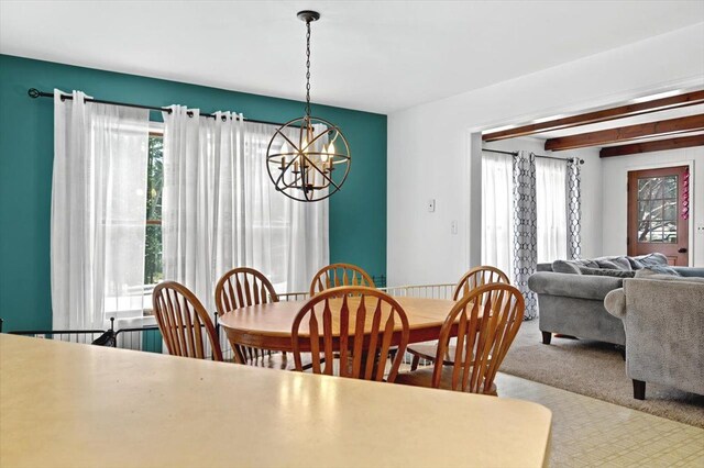 carpeted dining room with a notable chandelier and beam ceiling