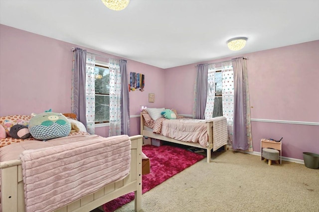 bedroom featuring baseboards and carpet
