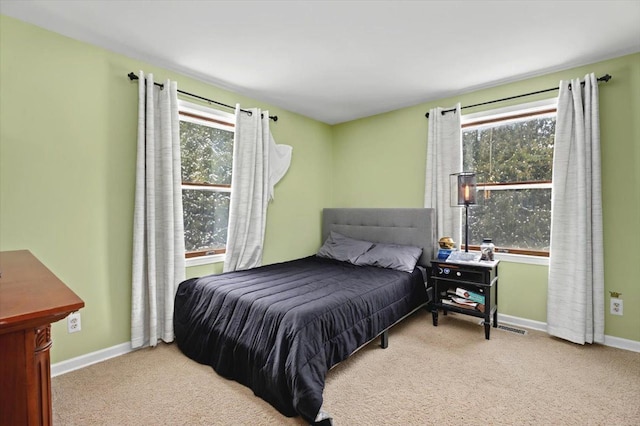carpeted bedroom with baseboards