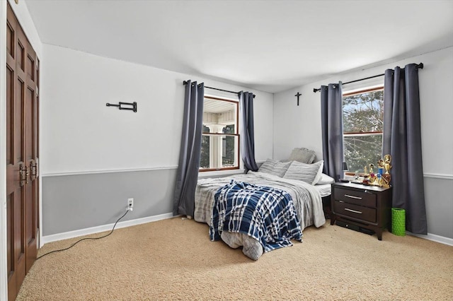 bedroom featuring carpet floors and baseboards