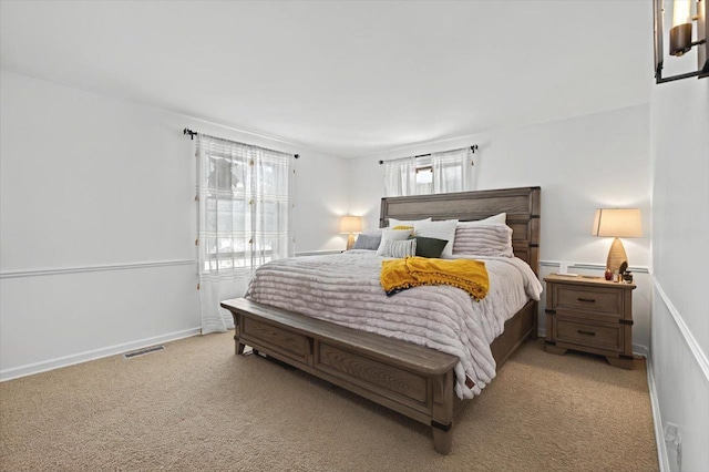 bedroom featuring light colored carpet, baseboards, and visible vents