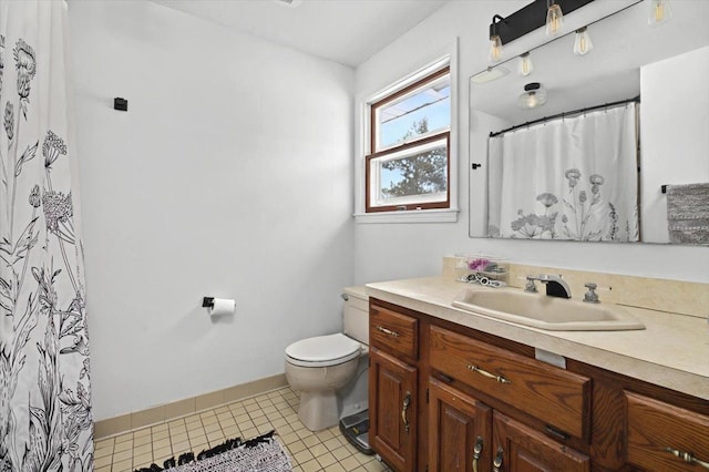 bathroom with vanity, toilet, tile patterned floors, and walk in shower