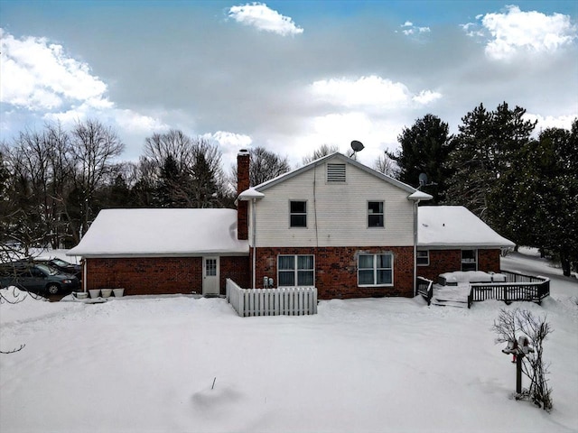 view of snow covered rear of property