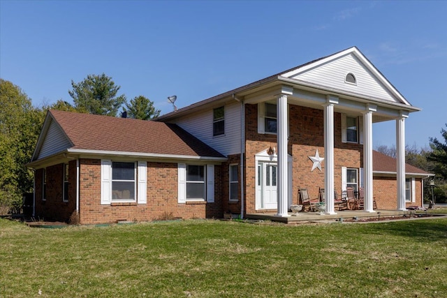 neoclassical / greek revival house featuring brick siding and a front lawn