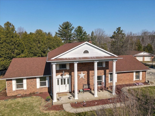 greek revival inspired property with brick siding
