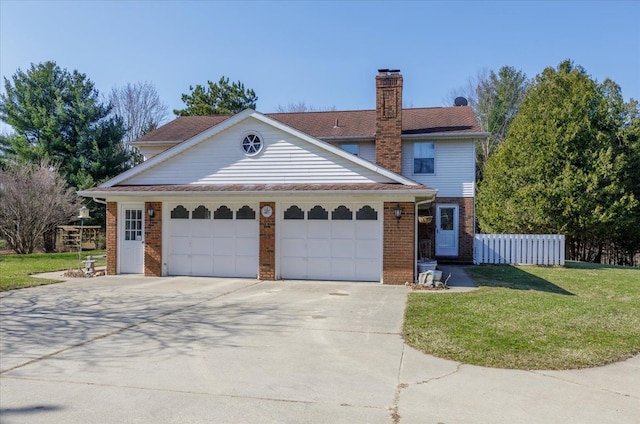 traditional-style home with a front yard, fence, brick siding, a garage, and driveway