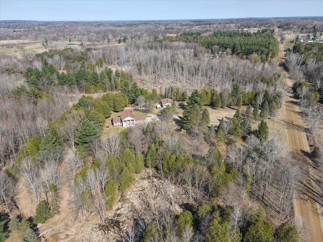 drone / aerial view featuring a view of trees