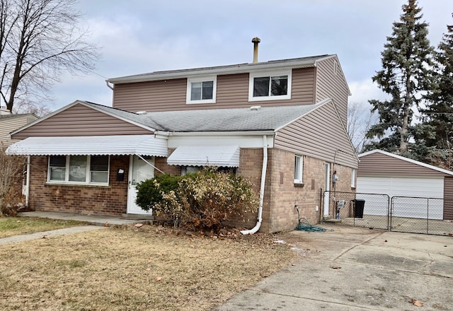 front of property featuring a garage, an outdoor structure, and a front yard