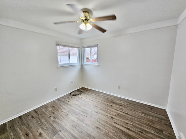 empty room with hardwood / wood-style floors and ceiling fan