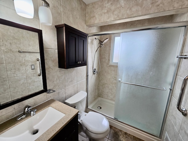 bathroom with walk in shower, toilet, tile walls, vanity, and decorative backsplash