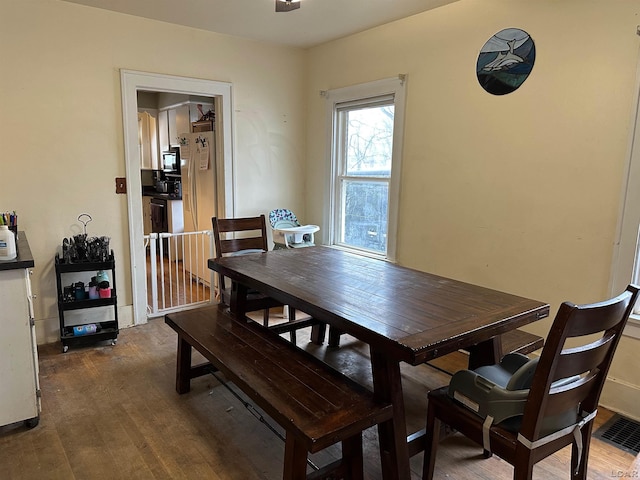 dining space with dark wood-type flooring