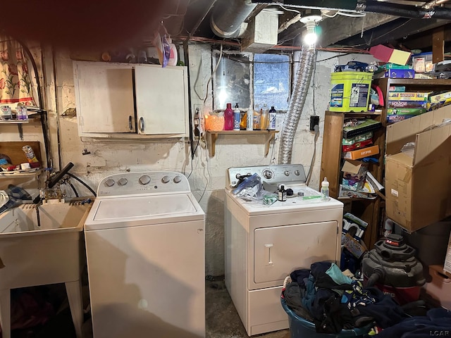 laundry room featuring cabinets, sink, and washer and dryer