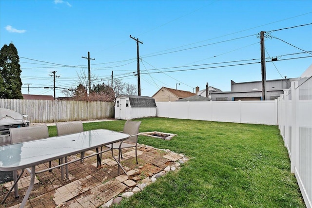 view of yard with a shed and a patio