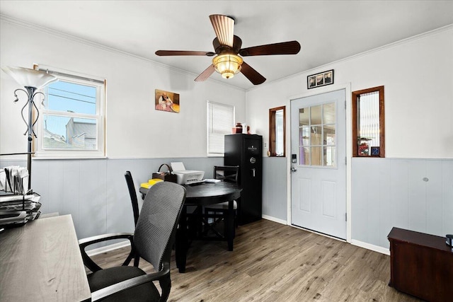 office featuring hardwood / wood-style floors, crown molding, and ceiling fan