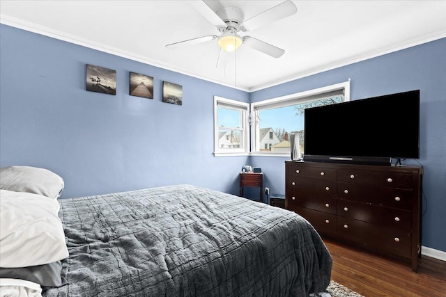 bedroom with crown molding, dark hardwood / wood-style floors, and ceiling fan