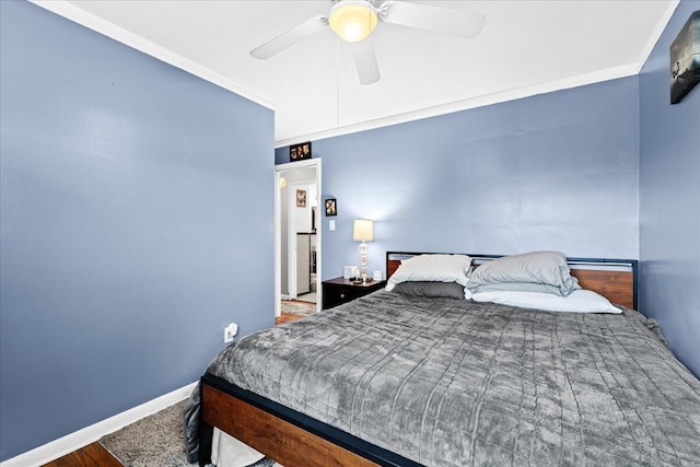 bedroom with ornamental molding and ceiling fan