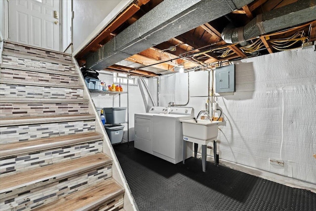 clothes washing area featuring separate washer and dryer, sink, and electric panel