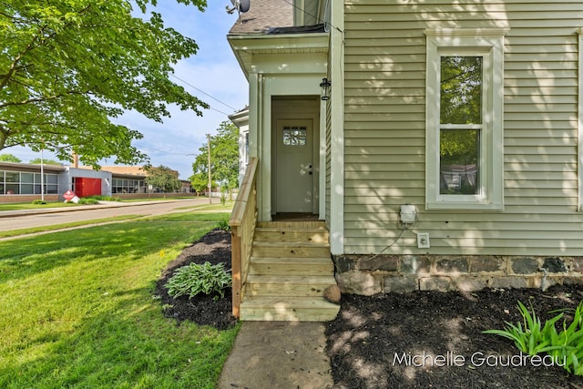 entrance to property with a lawn