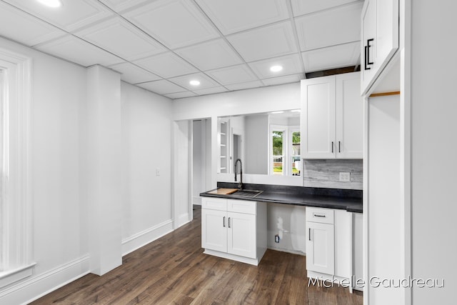 kitchen featuring white cabinetry, dark wood-type flooring, sink, and decorative backsplash