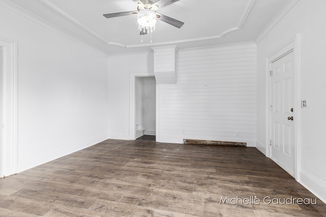 empty room featuring ornamental molding, dark hardwood / wood-style floors, and ceiling fan