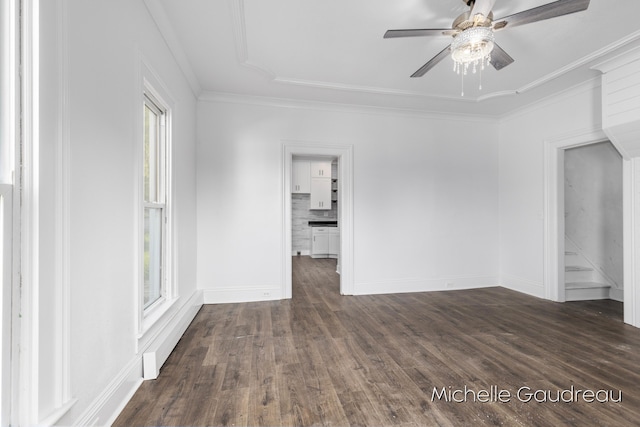 spare room with crown molding, dark hardwood / wood-style floors, and ceiling fan