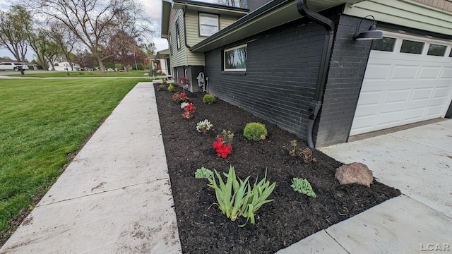 view of property exterior with a garage and a yard