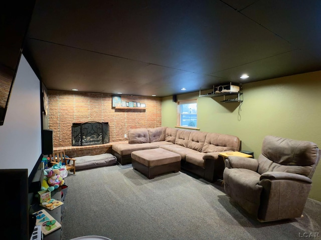 carpeted cinema room featuring a brick fireplace and brick wall