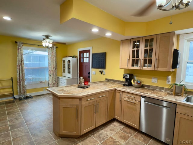 kitchen with stainless steel dishwasher, kitchen peninsula, and ceiling fan