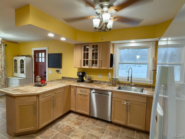 kitchen with ceiling fan, kitchen peninsula, sink, and dishwasher