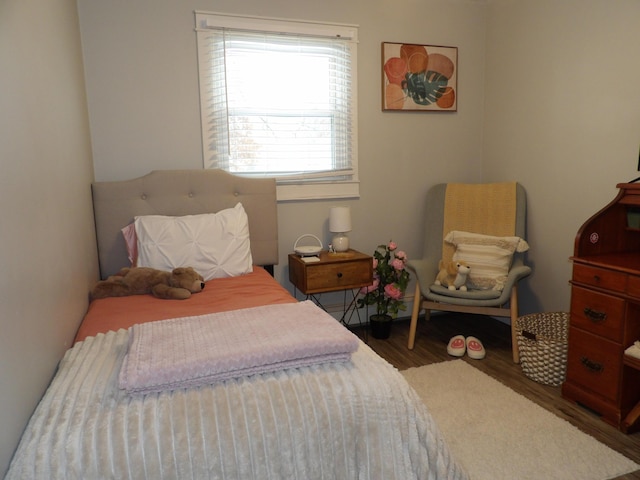 bedroom with dark hardwood / wood-style flooring