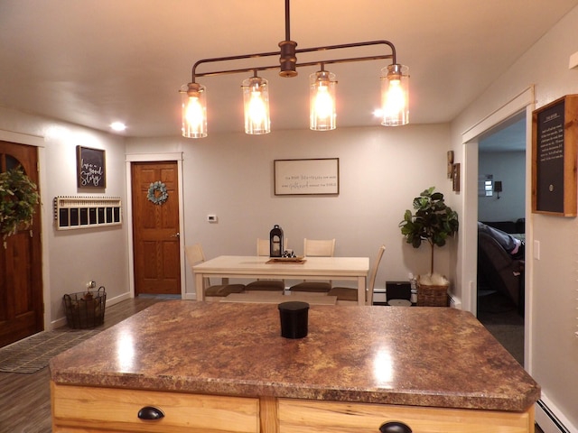 kitchen with light brown cabinetry, decorative light fixtures, a baseboard radiator, and dark hardwood / wood-style floors