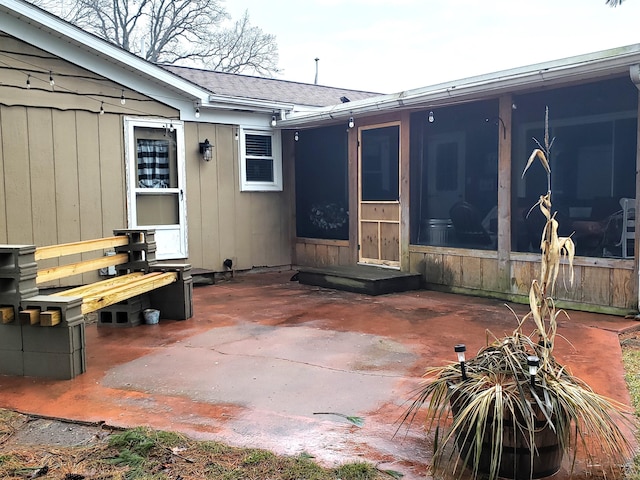 view of patio featuring a sunroom