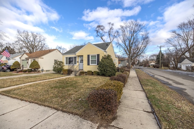 bungalow-style house featuring a front yard