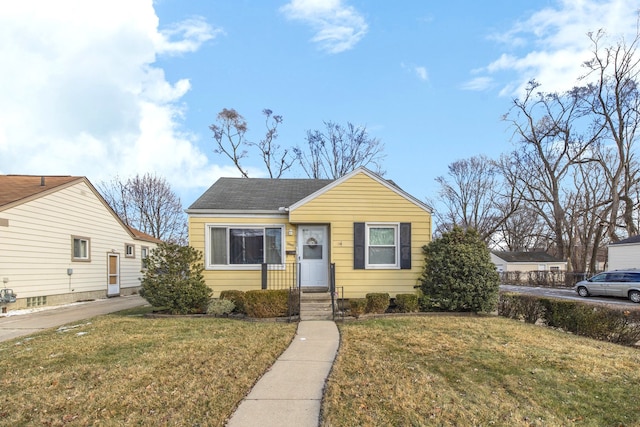 bungalow-style home with a front lawn