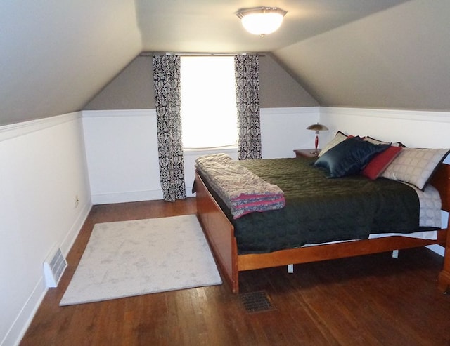 bedroom featuring hardwood / wood-style flooring and vaulted ceiling