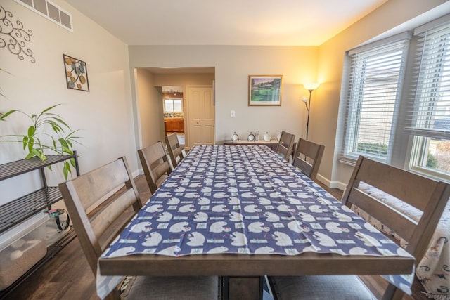 dining space featuring dark wood-type flooring