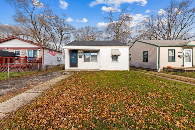 bungalow-style home with a front yard