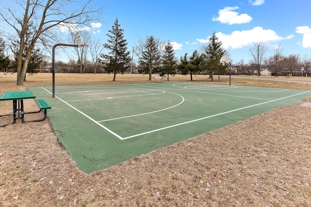 view of basketball court with a lawn