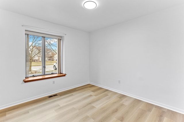 spare room featuring light hardwood / wood-style floors