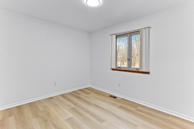 spare room featuring light hardwood / wood-style flooring