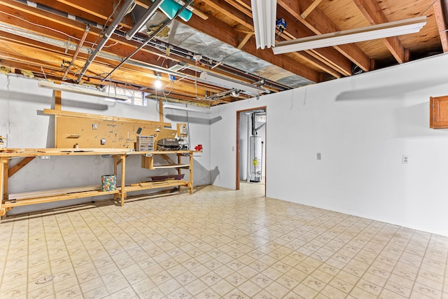 basement with a workshop area and gas water heater