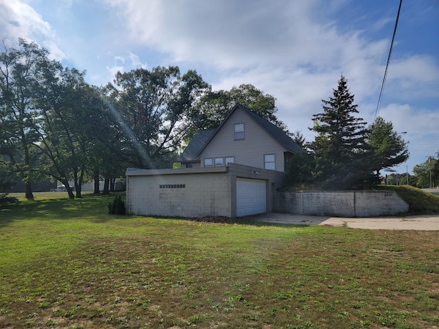 view of property exterior featuring a garage and a lawn