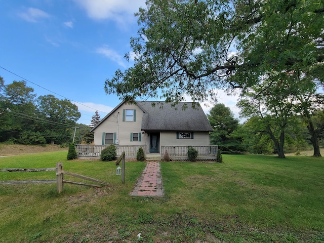 back of property with a wooden deck and a lawn