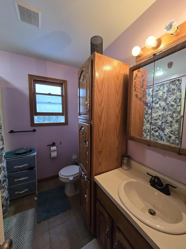 bathroom with tile patterned floors, toilet, and vanity