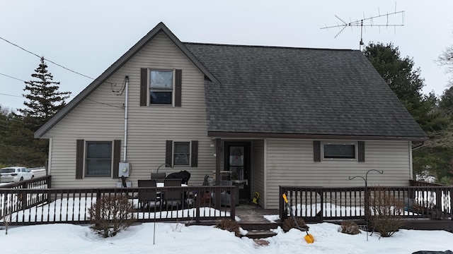 snow covered property with a wooden deck