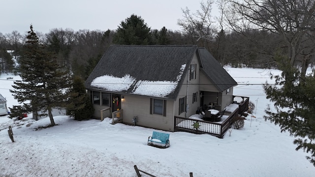 snow covered property with a deck