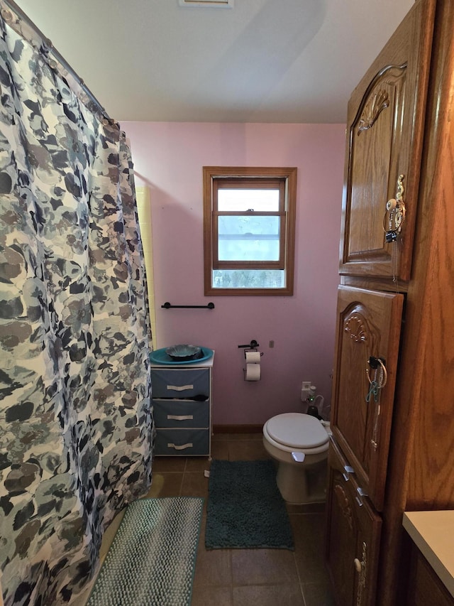 bathroom featuring vanity, curtained shower, tile patterned floors, and toilet