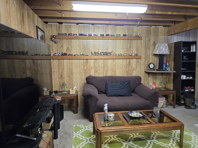 carpeted living room featuring wooden walls